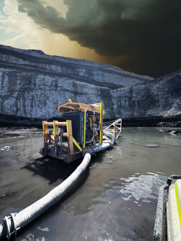 Aquaflo Hire skid mounted pumpset in flooded pit with storm clouds and rain in background