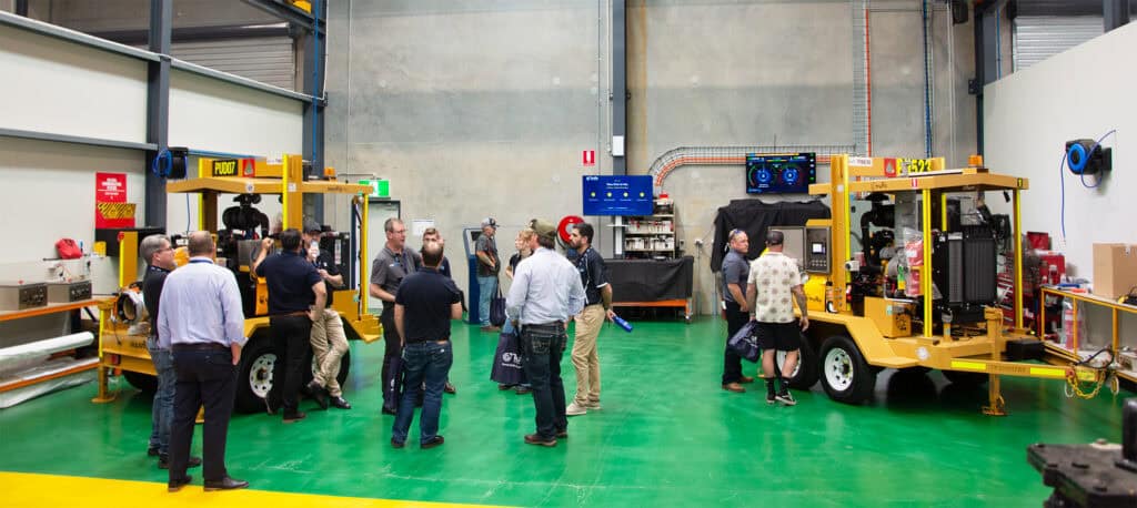 Guests inspecting pumpsets and the AquaBoss control panel