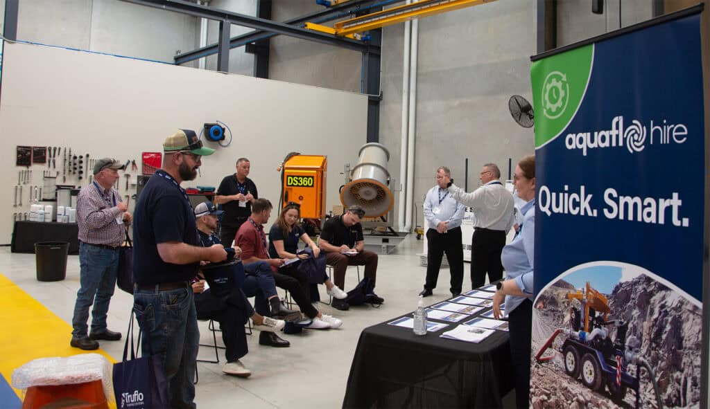 Visitors to Aquaflo Hire's open day learning about their capabilities and water management solutions.