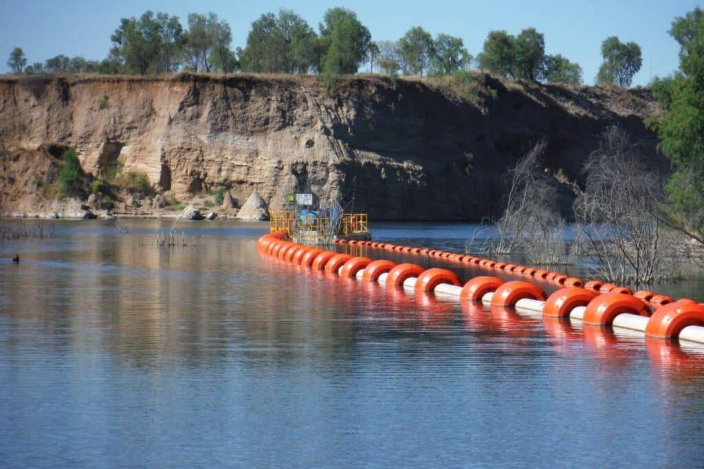 pipe floats with pontoon mounted pump-set in the distance