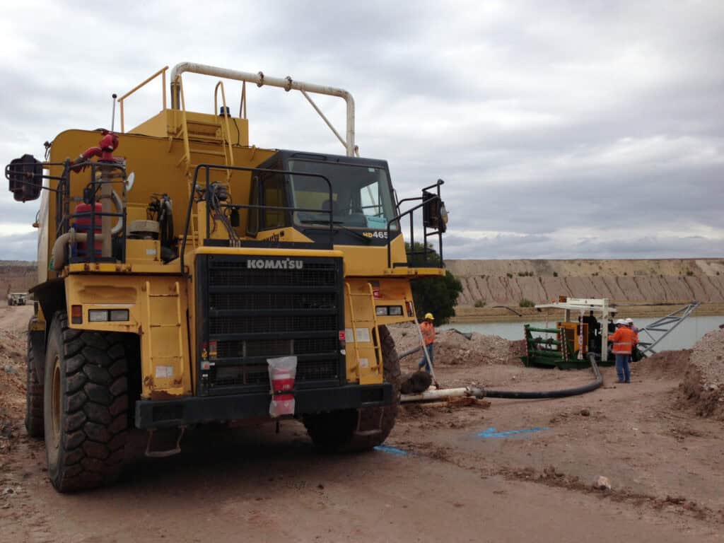 Skid mounted pumpset and truckfill point with large water truck in front of image