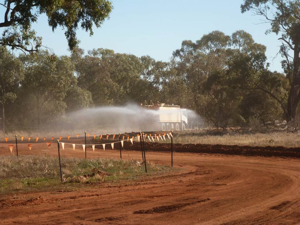 Water truck used to suppress dust on dirt road